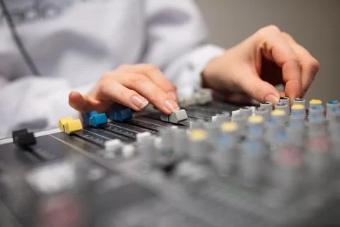 Midsection Of Radio Host's Hands Using Music Mixer In Studio Stock Photos