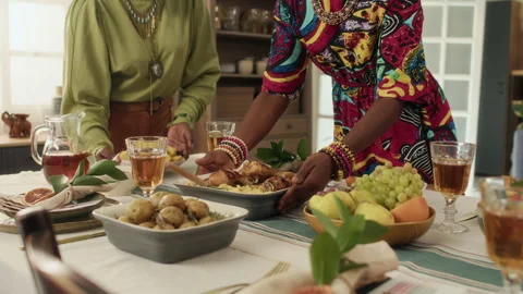 Midsection of Two Unknown Black Women Arranging Dishes on Holiday Table at Home Stock Footage 319891246