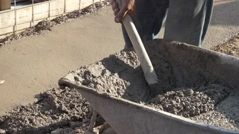 Midsection of unknown man hold shovel putting cement concrete on the ground b Stock Footage 220999513