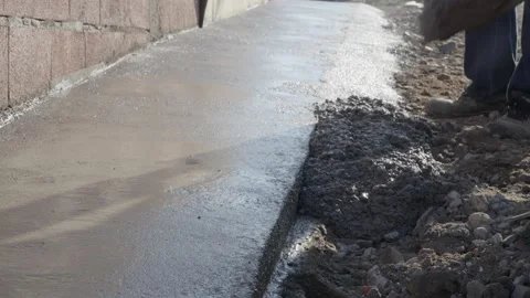 Midsection of unknown man hold shovel putting cement concrete on the building Stock Footage 220999541