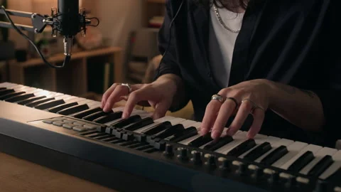 Midsection of Unknown Man Playing Midi Keyboard Controller in Home Music Studio Stock Footage 338065654