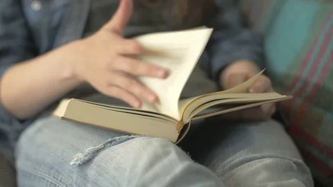 Midsection Of Woman Reading Book While Sitting On Sofa Stock Footage 79678602