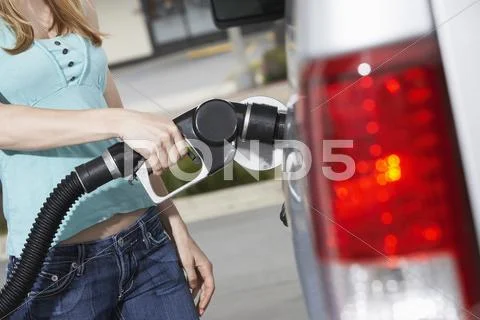 Midsection Of A Woman Refueling Her Car Stock Photos