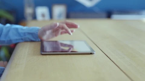 Midsection of woman scrolling digital tablet online at table Stock Footage 70176846