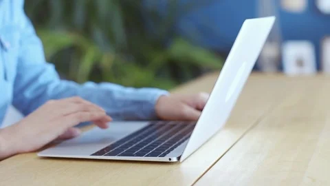 Midsection of woman scrolling online on laptop at home Stock Footage 70179853