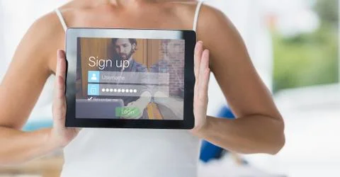 Midsection of woman showing sign up page on digital tablet Stock Photos