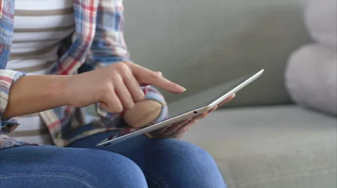 Midsection of woman using tablet computer on sofa Stock Footage 54778408