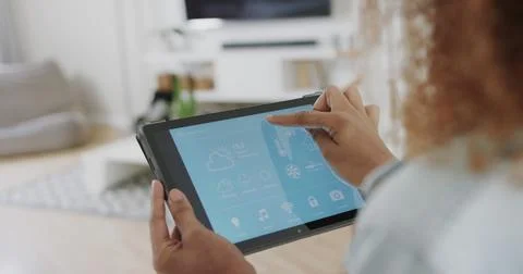Midsection of woman using tablet with smart home interface at home Photos