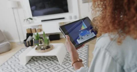 Midsection of woman using tablet with smart home interface at home, copy space Photos