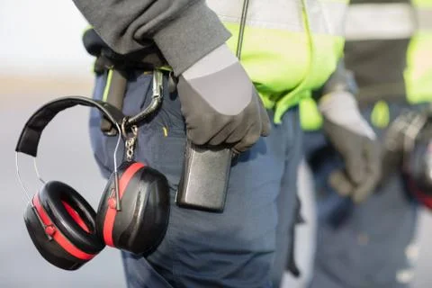 Midsection Of Worker With Ear Protectors Attached To Trouser Foto stock