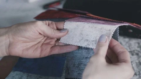 Midsection of young female designer going through fabric samples in studio Video stock 75897701