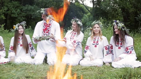 Midsummer. Group of young people of Slavic appearance are sitting around a Stock Footage 107409798