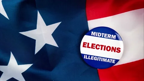 Midterm elections illegitimate text quote on election button laying on the st Stock Footage 170629654
