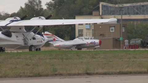 MiG-15UTI NATO: Midget - Soviet double training aircraft moves parking lot. Stock Footage 117541409