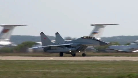 MiG-29 fighter aircraft with additional fuel tanks landed on runway. Stock Footage 107584268