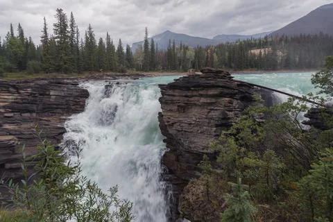 Mighty Athabasca Falls on a cloudy, rainy day in Jasper National Park, Alberta Stock Photos