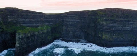 The mighty Cliffs of Moher in aerial view. Waves against the rocks. Stock Footage 127924325