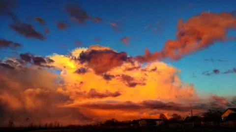 A mighty cloud rushing in the blue see. Stock Photos