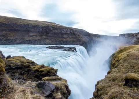 A mighty waterfall, falling into a gorge, spreading on a vast distance. Botto Stock Photos