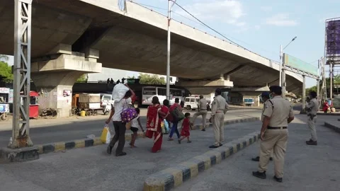 Migrant workers Covid 19 Lockdown India special Train Bus back home police duty. Stock Footage 130796994