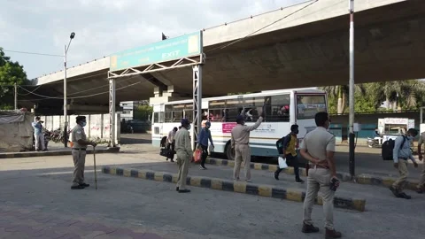 Migrant workers Covid 19 Lockdown India special Train Bus back home police duty. Stock Footage 130797040
