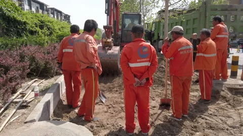 Migrant workers doing road maintenance work, Beijing, China. Stock Footage 154462448