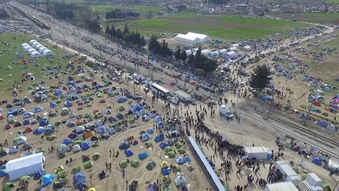 Migrants and refugees wait on the Greece-Macedonia border near Idomeni - drone Video stock 98937997