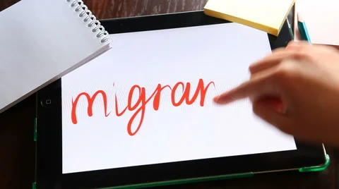 Migrants, hand writes word on tablet. 動画素材 62959186