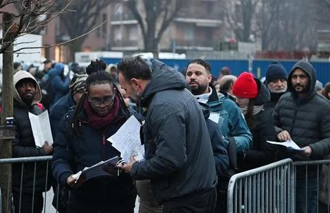 Migrants queue outside the immigration office in Turin, Italy - 23 Jan 2025 Stock Photos