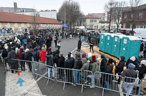 Migrants queue outside the immigration office in Turin, Italy - 23 Jan 2025 Stock Photos