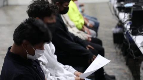 Migrants seated while waiting to be processed at El Paso Processing Center Stock Footage 269902355