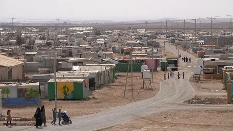 Migrants walk through Syrian refugee camp in Jordan Stock Footage 71531311