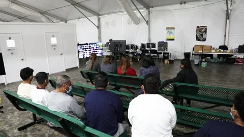 Migrants watching information video while waiting at El Paso Processing Center Stock Footage 269902160