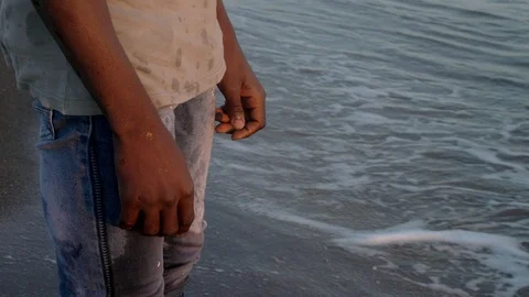 Migration, missing homeland.lonely black migrant observing ocean at sunset. Stock-Footage 96340965