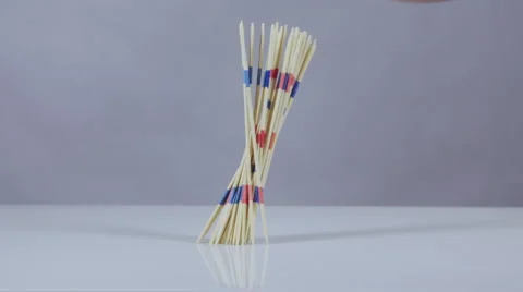 Mikado sticks fall on white surface slow motion Stock Footage 58761465