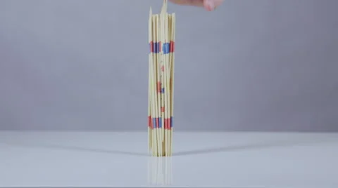 Mikado sticks fall on white surface slow motion Stock Footage 58761480