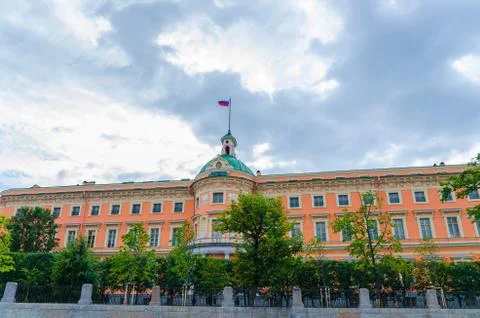 Mikhailovsky Castle with russian flag on top, blue dramatic sky background Stock Illustration