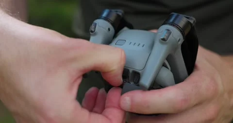 Milan, Italy - 08/01/2024: Hands inserting a micro SD memory card into Stock Footage 282462292