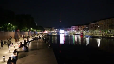 Milan new Darsena, redeveloped docks area with people at night Stock Footage 64180695