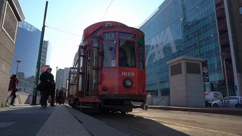Milan's vintage red tram arrive at the stop in Garibaldi Stock Footage 103804366