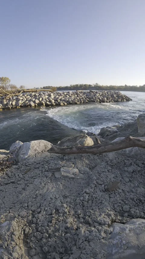Mild water surface gently flows over polished rocks peacefully Stock Footage 321658639