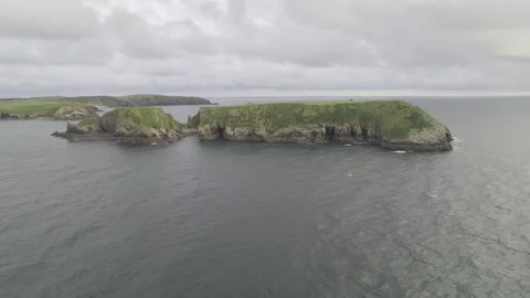 Mild waves crashing to rocky cliffs on island shore Stock-Footage 166597924