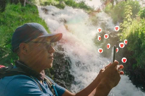 Miling backpacker guy using mobile on summer vacation in mexico Stock Photos