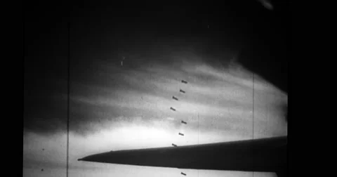Military airplane dropping bomb during shuttle-bombing operations Stock Footage