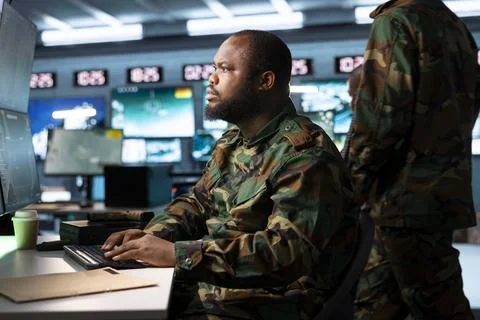 Military analyst working at computer in army headquarters Stock Photos