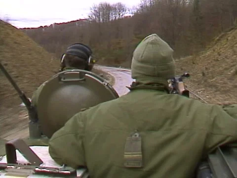 Military, armoured fighting vehicle patrol through Bosnia Stock Footage