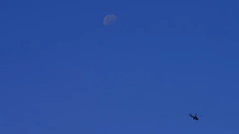Military attack helicopters with moon in the background Stock Footage 113230581