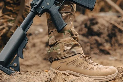 Military boot and automatic weapon Stock Photos