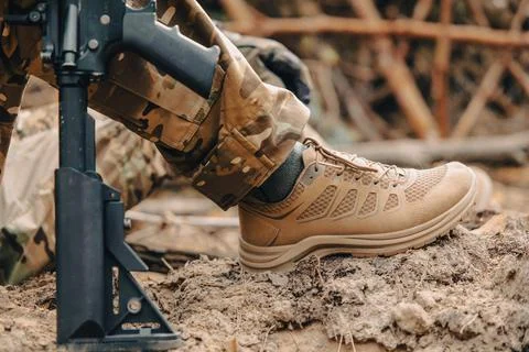 Military boot and automatic weapon Stock Photos