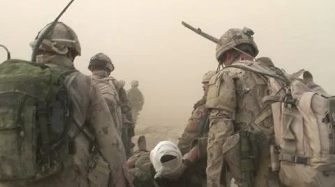 Military, Carrying wounded soldier to helo in Afghan. Stock Footage